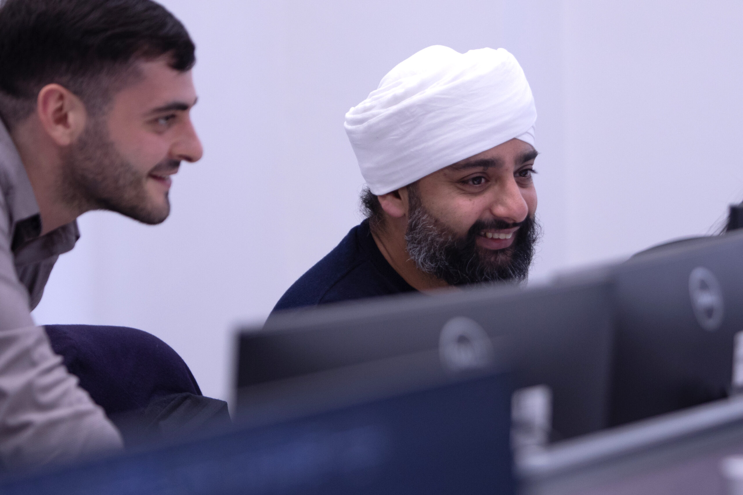 Gerald-Edelman-team-members-smiling-computer-screen